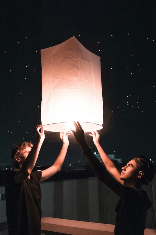 people releasing lanterns